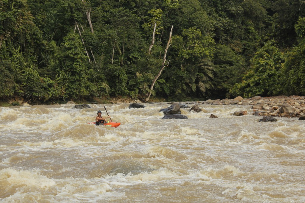 Nick Bennett enjoying high water in Malaysia. Just after this rapid, the water flows off a waterfall into a pool full of hungry crocodiles.  Luckily the locals had warned us about it!